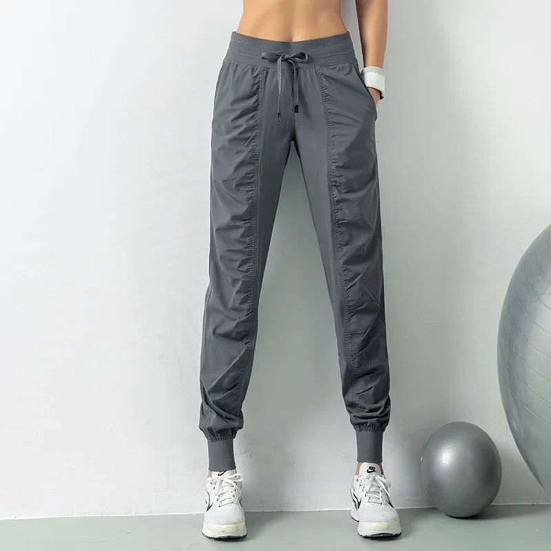 Pantalones deportivos de secado rápido para mujer con dos bolsillos laterales