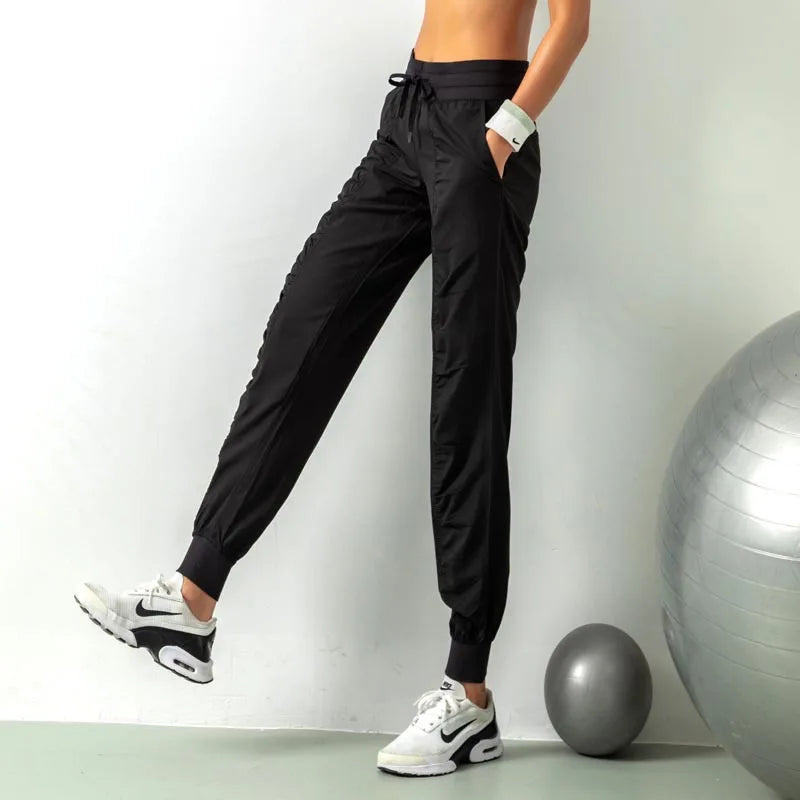 Pantalones deportivos de secado rápido para mujer con dos bolsillos laterales